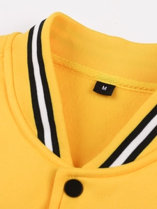 Detailed close-up of yellow knit jacket collar with black and white striped ribbed neckline