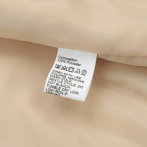 Detail of internal care label on polyester sport jacket with washing symbols