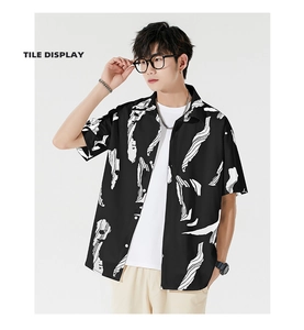 Detail of the casual lapel and white abstract print on the black short-sleeve shirt
