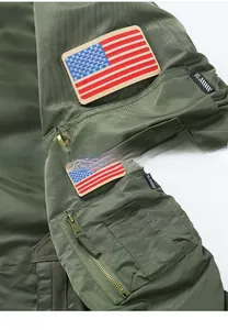 Detail of army green MA1 bomber jacket showing zipper sleeve pocket and flag patch