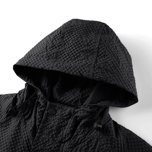 Detail of hooded jacket showing 3D waffle texture fabric with drawstring and matte snaps