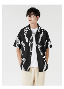 Detail of loose fit Hawaiian shirt with black and white abstract print and button closure