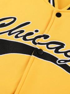 Detailed view of the yellow varsity jacket with embroidered Chicago text and ribbed collar