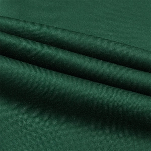 Detailed macro view of dark green fine rib knit fabric texture with soft drapery