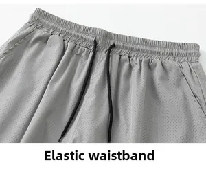 Close-up of grey elastic waistband with black drawstrings and breathable mesh fabric