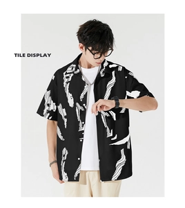 Macro shot of black short sleeve Hawaiian shirt featuring white abstract graffiti pattern