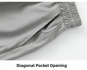 Detail of grey mesh sports shorts with elastic waistband and slanted side pocket design