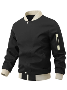 Detail of black bomber jacket featuring beige ribbed collar and zippered sleeve pocket
