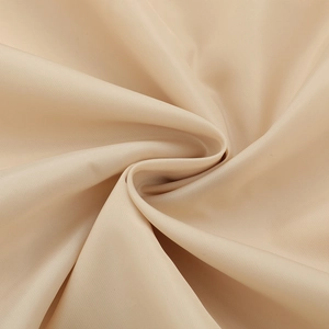 Close-up of silky beige fabric texture with soft ripples and elegant satin luster