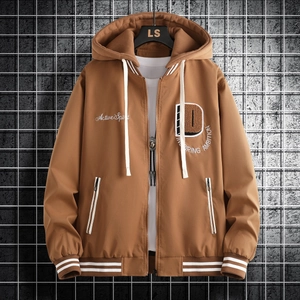 Close-up of khaki jacket with varsity letter D embroidery and striped ribbed cuffs