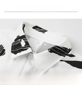 Detailed view of white Hawaiian shirt collar with black abstract stripes and size label L
