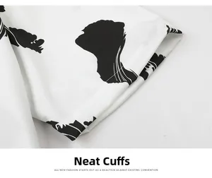 Close-up of neatly stitched cuff and abstract black print on white shirt fabric