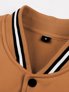 Close-up of baseball collar with black and white stripes and fleece lining on jacket