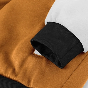 Detailed view of orange and white jacket stitching with black ribbed cuffs