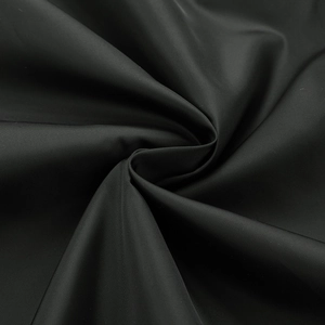Detailed macro view of black synthetic breathable fabric texture on a men's baseball jacket