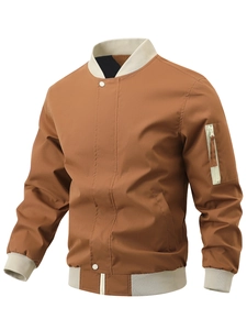 Detail of tan bomber jacket featuring cream ribbed cuffs and a utility zipper sleeve pocket