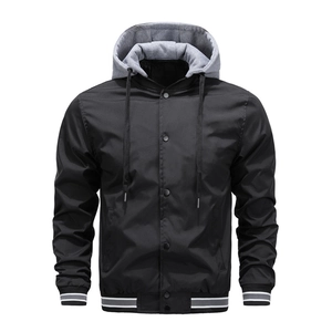 Detail of hooded baseball jacket featuring snap closure and striped ribbed cuffs