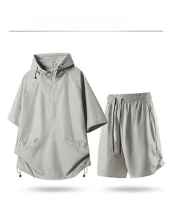Detail of light gray mesh fabric sports set featuring a hooded pullover and shorts