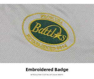 Close-up of high-quality brand embroidery badge on grey mesh fabric shorts