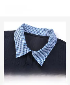Detail of navy blue knit shirt featuring textured jacquard and gingham plaid polo collar