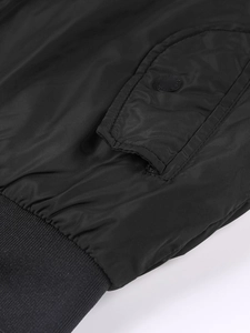 Detail of jacket side flap pocket with matte metal button and ribbed hem texture