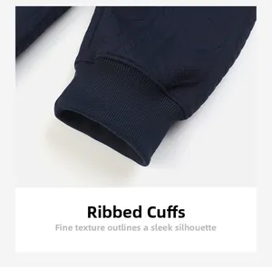 Macro detail of navy blue ribbed cuff and textured jacquard knit fabric on sweatshirt