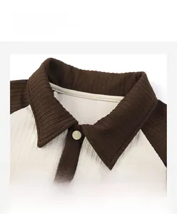 Close-up of contrast polo collar and button placket on waffle knit textured shirt