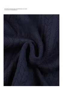 Detail of dark blue sweatshirt fabric featuring 3D diamond jacquard knitting texture