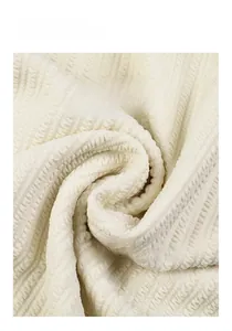 Detailed close-up of cream white 3D textured jacquard fabric with vertical wave patterns
