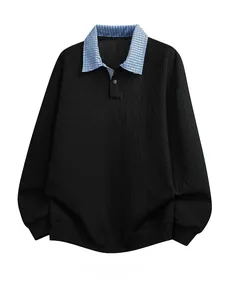 Macro detail of men's black cable knit sweatshirt with blue checkered polo collar