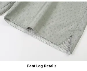 Detail view of light gray shorts with laser-cut holes and breathable white mesh lining
