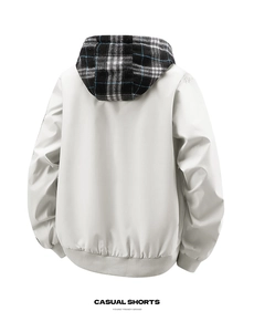 Detail of grey outdoor jacket featuring a detachable hood with blue and white plaid pattern