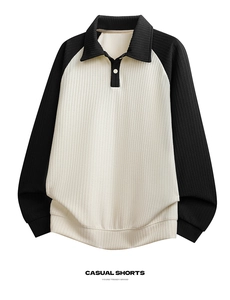 Detail of waffle knit fabric texture and color-block polo collar on men's long sleeve top