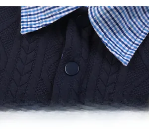 Detail of dark blue knit cardigan with plaid shirt collar and buttoned placket