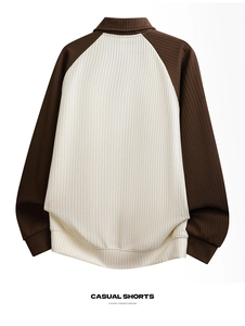 Close-up of contrast knit texture and raglan sleeve detail on the polo sweatshirt