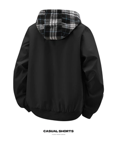 Detail view of men's jacket back showing plaid lined hood and ribbed cuffs