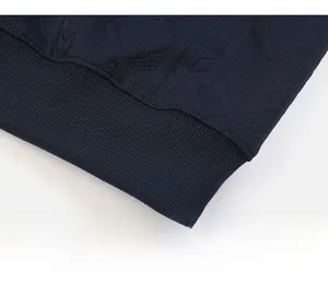 Macro view of navy blue ribbed hem and geometric knit texture on men's sweatshirt