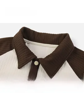 Detail view of Polo collar with brown and beige knit texture and button closure