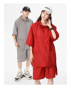 Detail of hooded short sleeve tracksuit showing breathable mesh fabric and half-zipper design