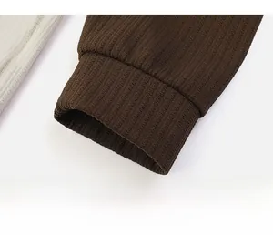 Detail of dark brown ribbed knit cuff with high-quality vertical texture and elastic finish
