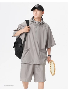 Detail of grey athletic set showing breathable mesh fabric and casual hooded top style