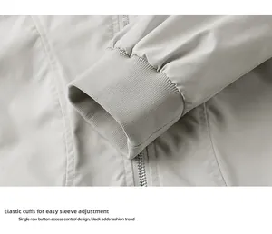 Detail of light gray outdoor jacket featuring elastic ribbed cuffs and metal zipper closure