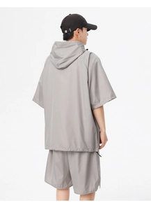 Detail view of grey quick-dry sports set showing breathable mesh texture and hooded design