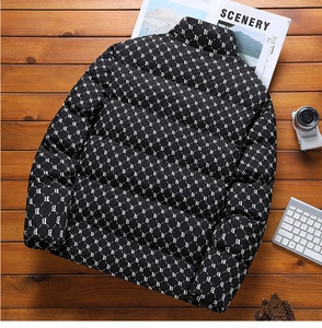 Detail of black quilted men's puffer jacket with white B letter pattern and stand collar