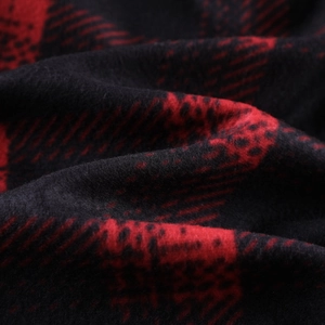 Detailed macro view of red and black buffalo plaid fleece fabric texture and softness
