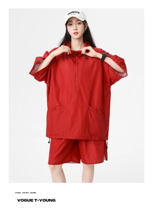Close-up of red quick-dry sportswear with breathable mesh fabric and drawstring hood