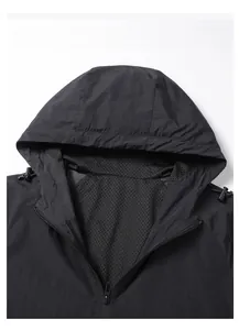 Detail of black hooded jacket showing breathable mesh lining and zipper collar area