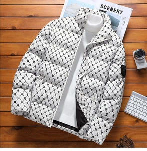 Detail of white winter puffer jacket with black monogram print and shield arm patch