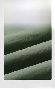 Macro detail of high-quality green nylon bomber jacket showing durable fabric texture