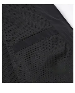 Detail of a breathable mesh lining and a secure inner pocket on a black outdoor jacket